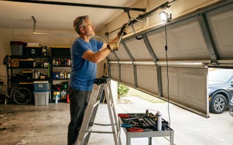 Homeowner in Dallas TX adjusting uneven garage door tracks