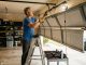 Homeowner in Dallas TX adjusting uneven garage door tracks