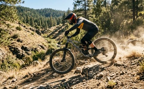 A mountain biker riding a Canyon Spectral 125 AL 5 down a rocky trail.