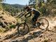 A mountain biker riding a Canyon Spectral 125 AL 5 down a rocky trail.