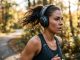A runner wearing lightweight ergonomic headphones during an outdoor morning workout.