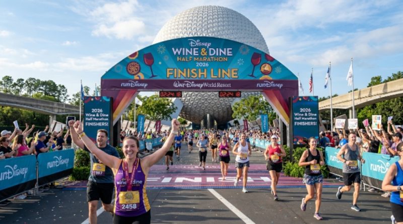Runners crossing the finish line at the Disney Wine and Dine Half Marathon 2026 in front of EPCOT at Walt Disney World Resort in Orlando, Florida