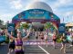 Runners crossing the finish line at the Disney Wine and Dine Half Marathon 2026 in front of EPCOT at Walt Disney World Resort in Orlando, Florida