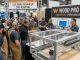 Professional woodworkers watching a live CNC router demonstration on the expo floor at Wood Pro Expo Lancaster 2026 at Spooky Nook Sports Center in Manheim, Pennsylvania